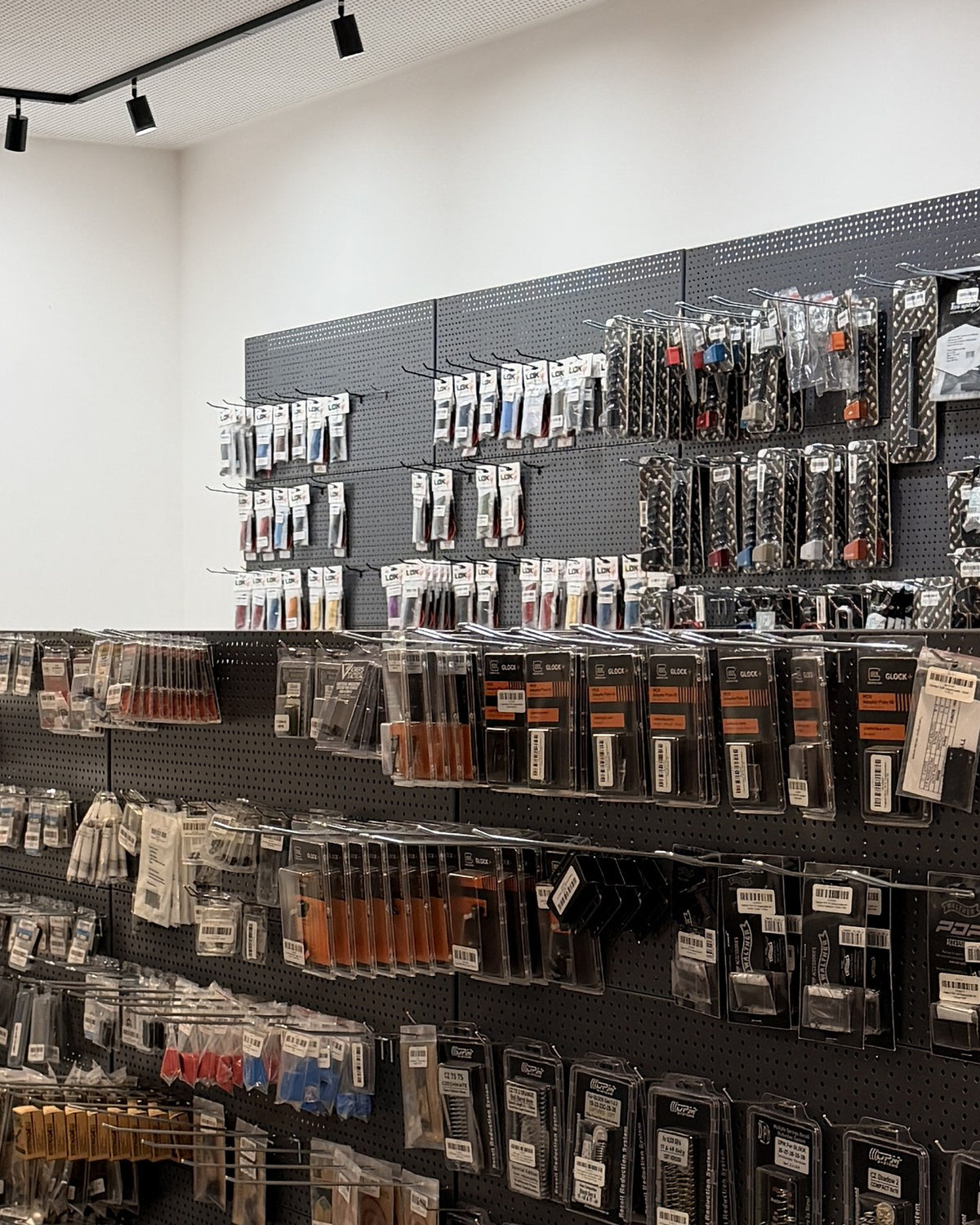 Fully stocked pegboards with tuning parts in the Dynamic Shooting Austria store